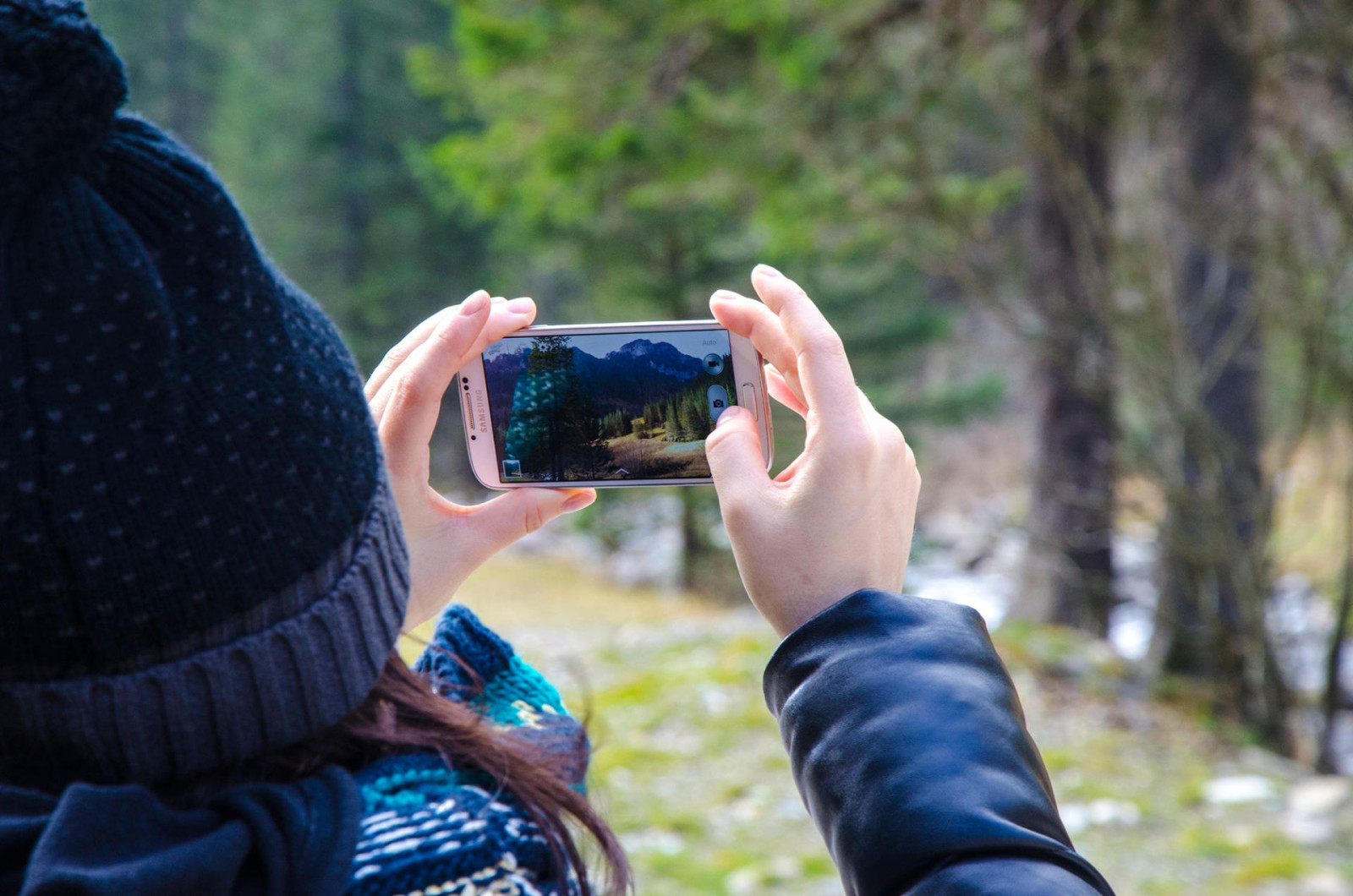 Women holding a Samsung phone and taking a picture. There are several great Android apps for language learning.